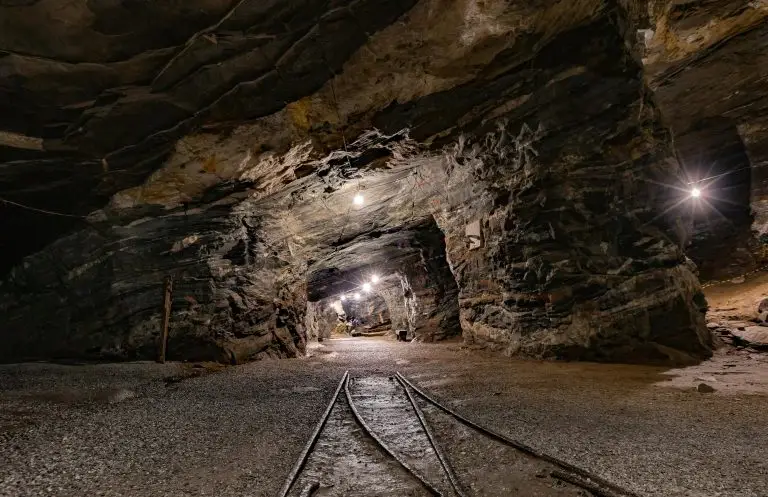 Explore the mysterious depths of Passagem de Mariana, MG, Brazil, with this illuminated underground mine tunnel.